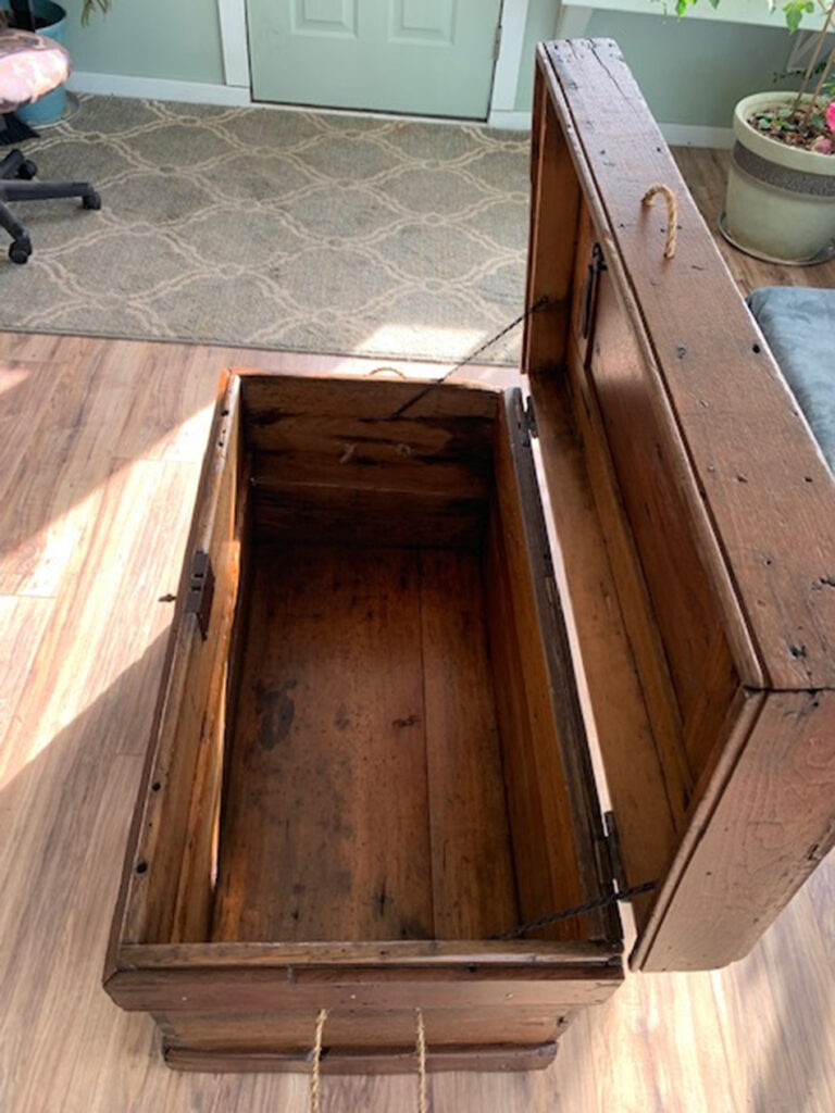 Newly refinished open wooden trunk side view